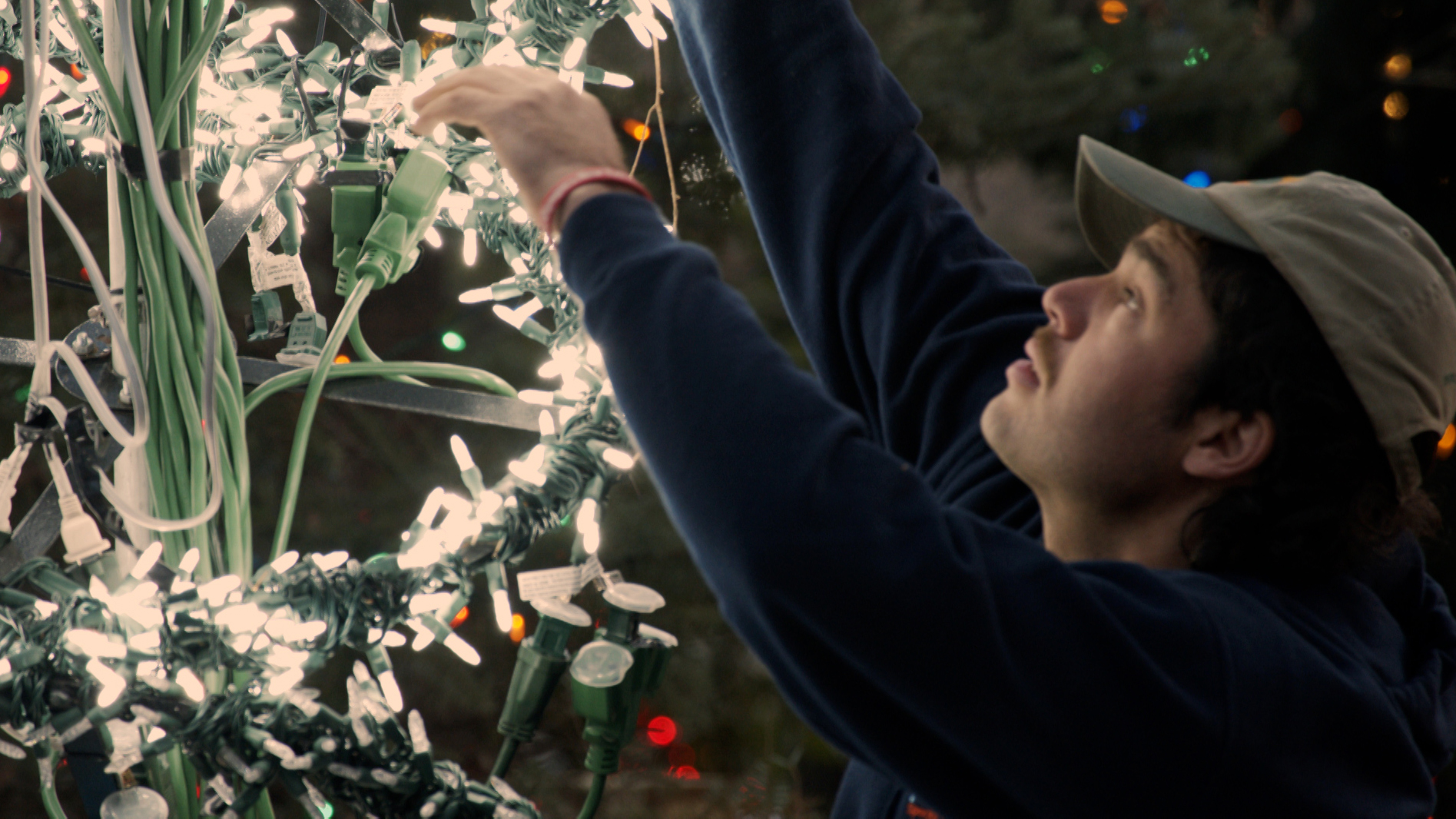 Peter hanging up Christmas lights. Credit: WXXI.
